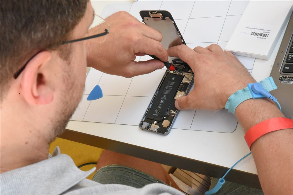 Technician resolving a phone software issue