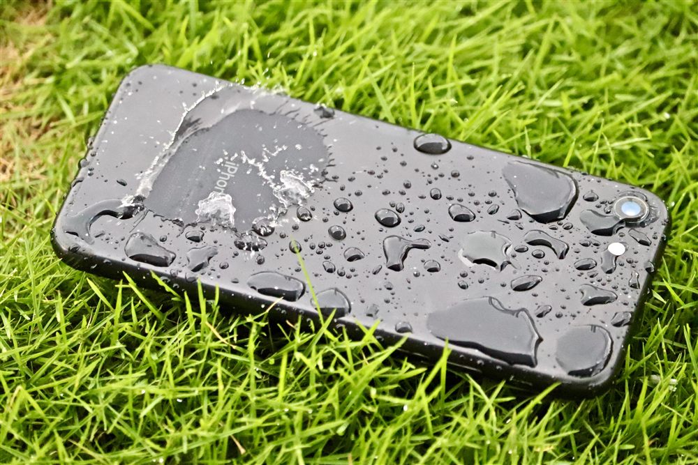 Water-damaged phone being dried and recovered